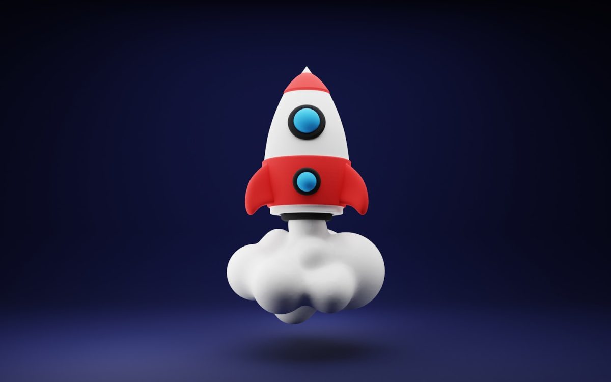 a red and white toy rocket on a blue background