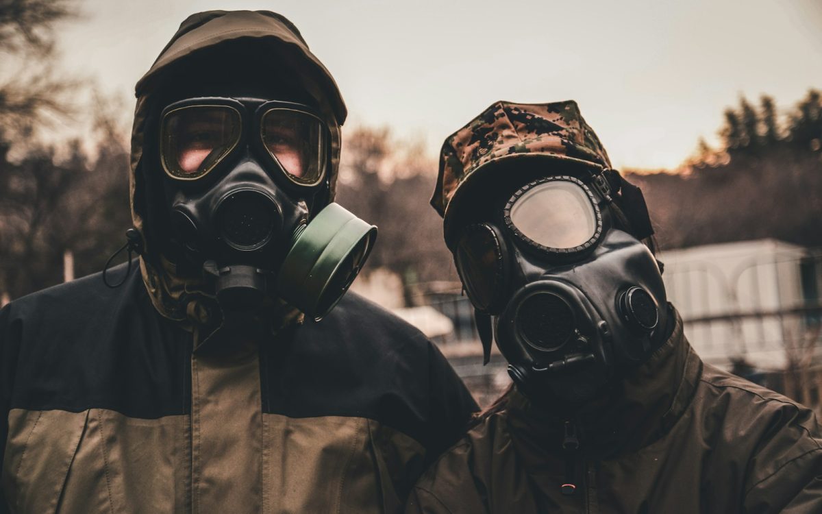 grayscale photo of person wearing gas mask