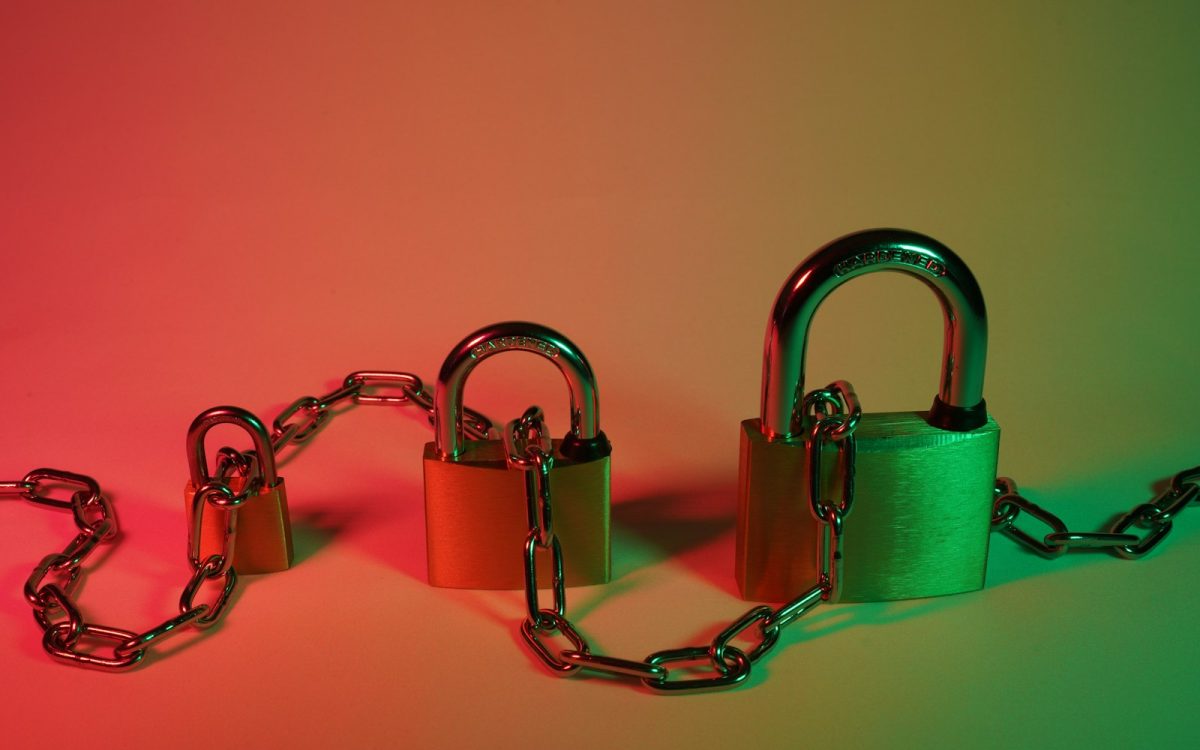 green padlock on pink surface